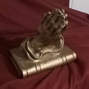 God Hand praying on a Bible